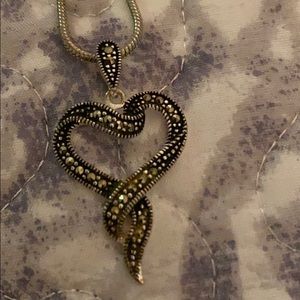 Silver with black heart necklace .